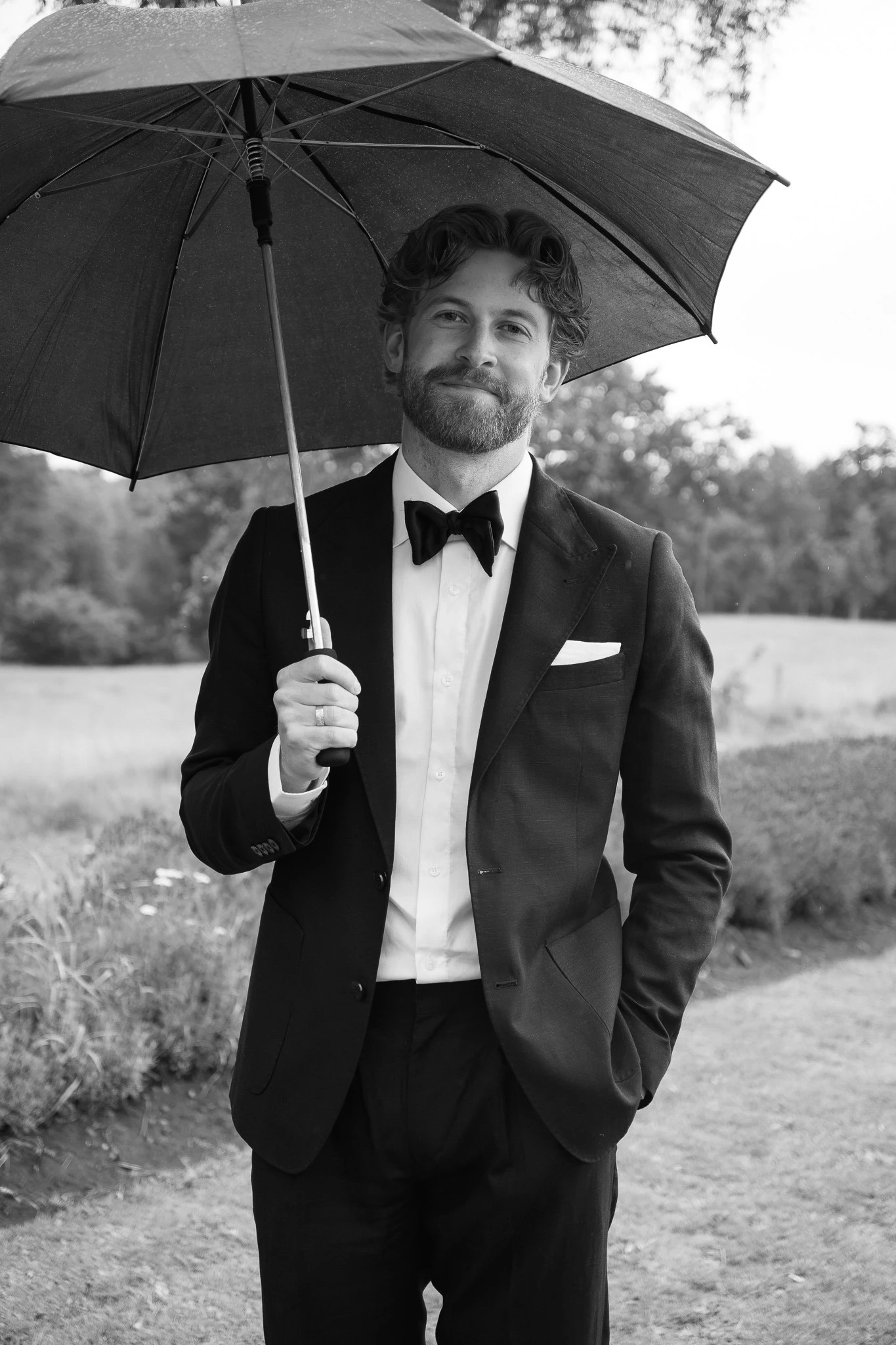 Groom under an umbrella